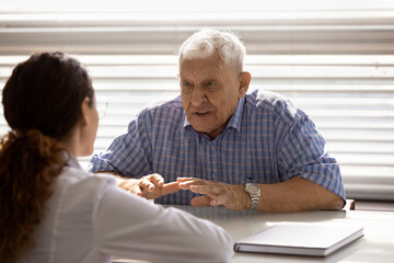 Woman talking with an older gentleman at a table
